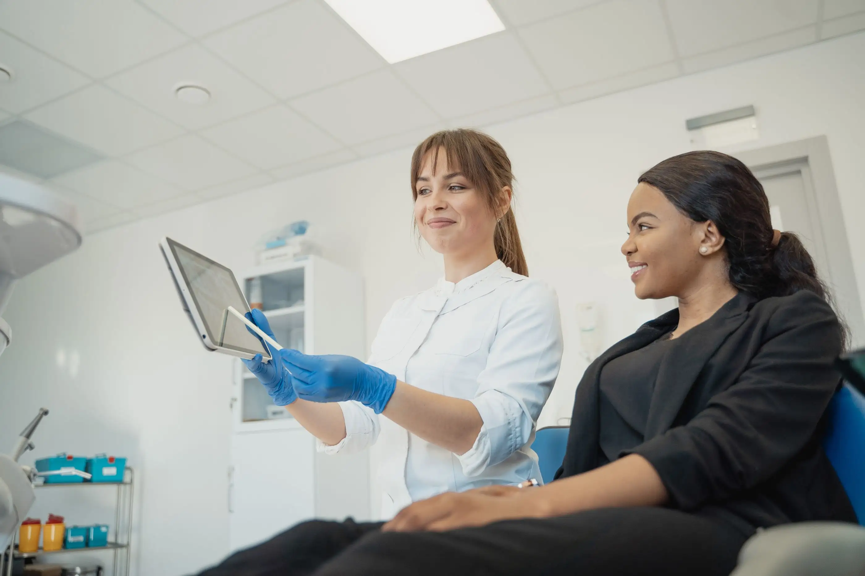 A clinician shows a patient information on a tablet.