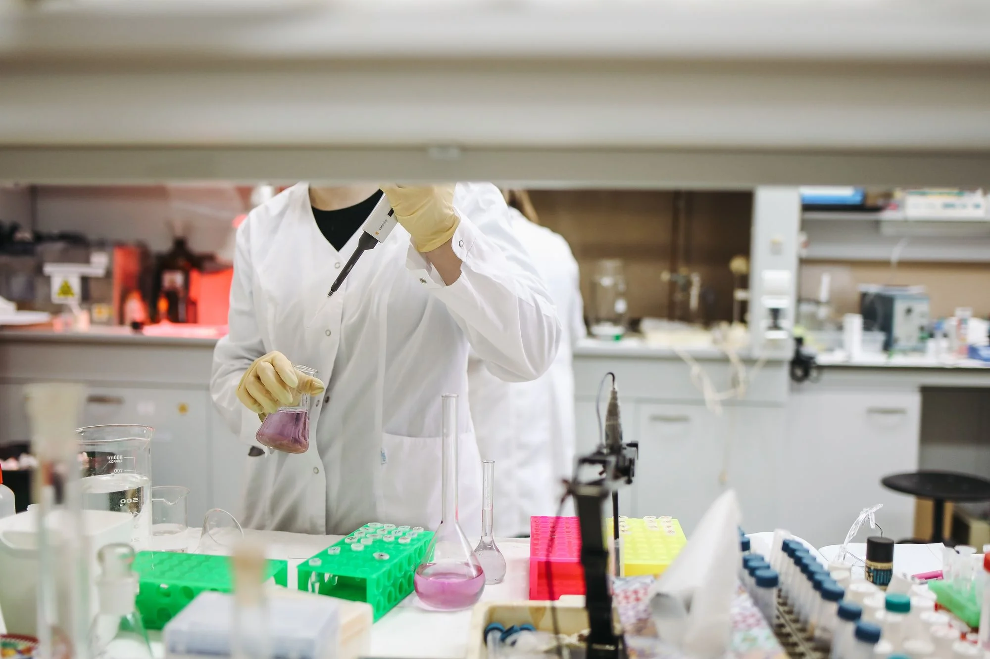 A scientist handles samples in a laboratory.