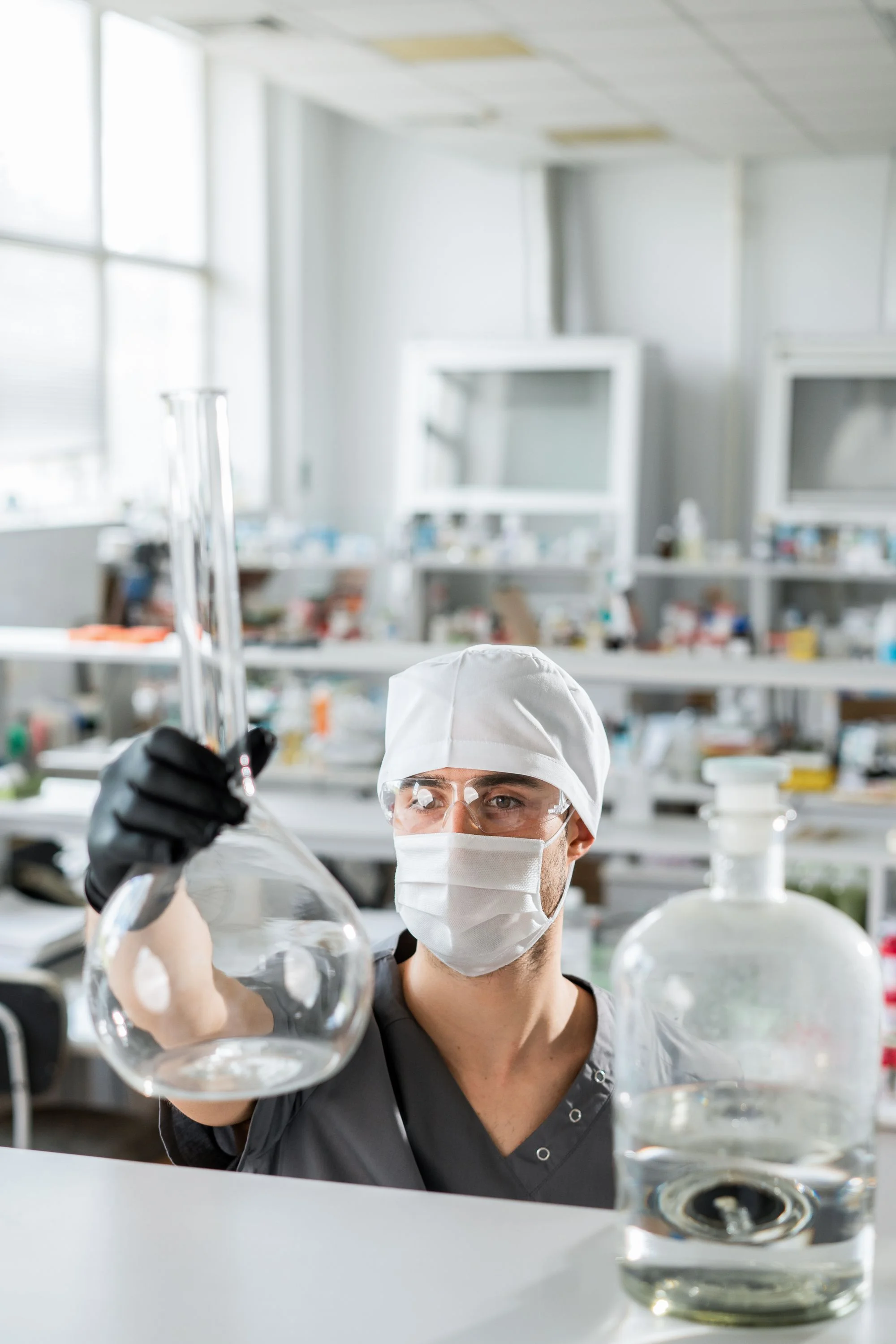 A scientist works with glassware in a laboratory.